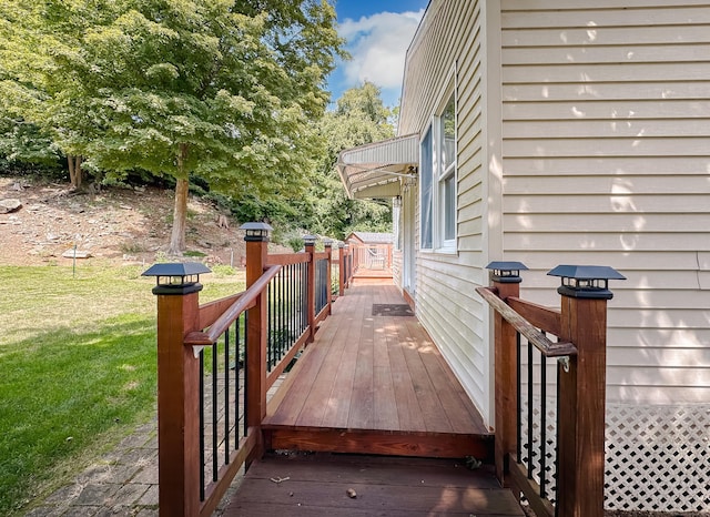 wooden terrace featuring a lawn