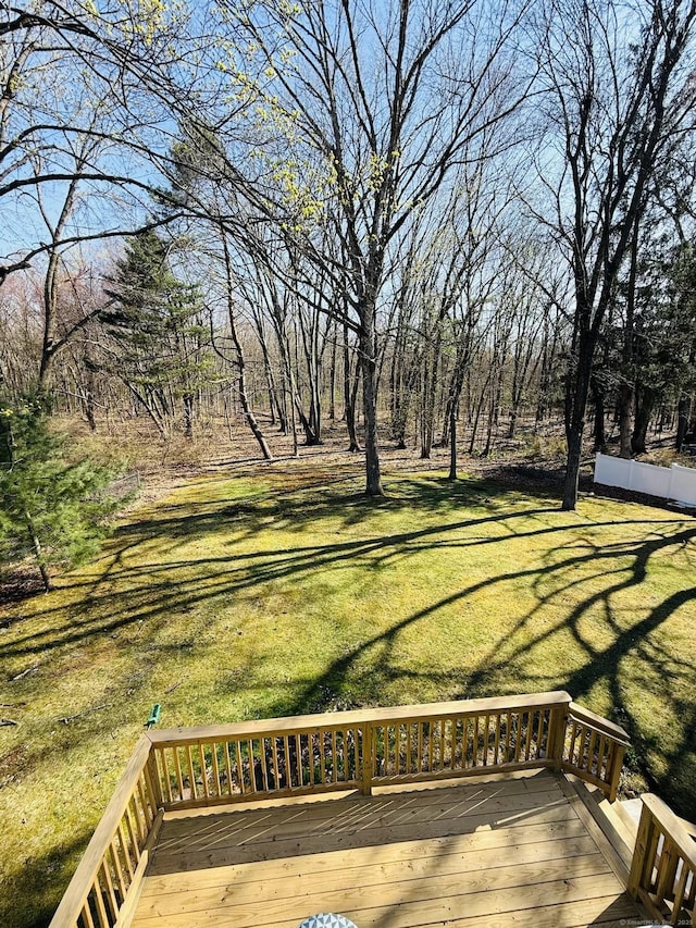 wooden terrace featuring a lawn