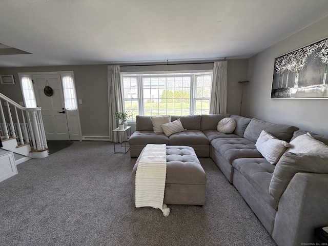 living area with baseboards, baseboard heating, carpet flooring, and stairs