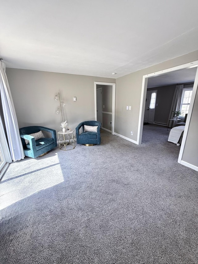 unfurnished room with baseboards and carpet