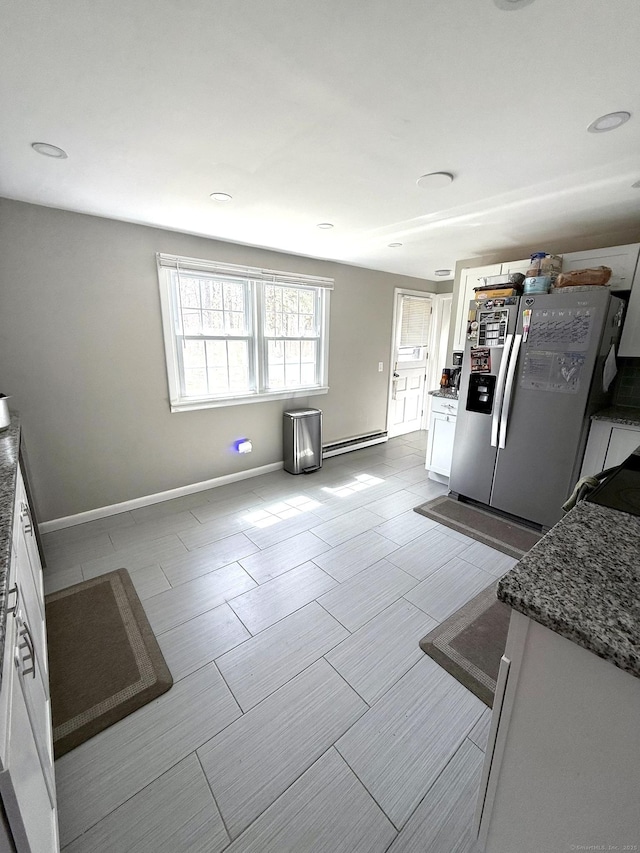 737 Burnham St, East Hartford, CT 06108 - kitchen featuring white cabinets, baseboards, a baseboard radiator, and stainless steel refrigerator with ice dispenser
