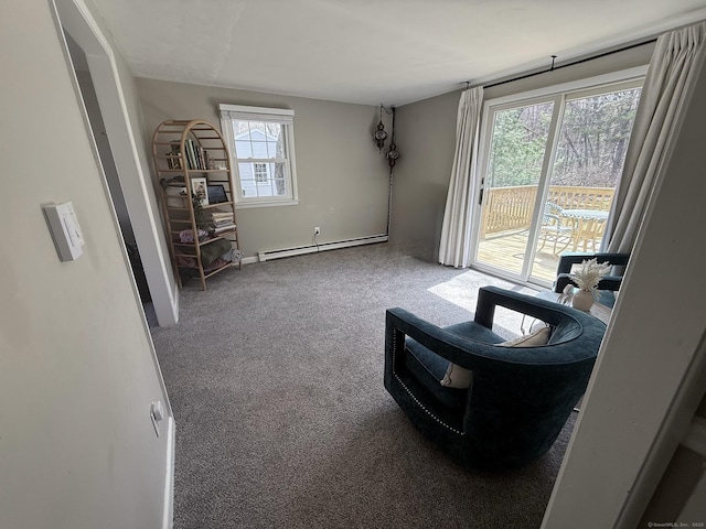 living area with a baseboard heating unit and carpet floors