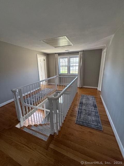 737 Burnham St, East Hartford, CT 06108 - stairs featuring wood finished floors and baseboards