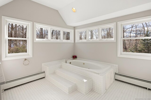 full bathroom featuring vaulted ceiling, a baseboard radiator, a whirlpool tub, and tile patterned floors