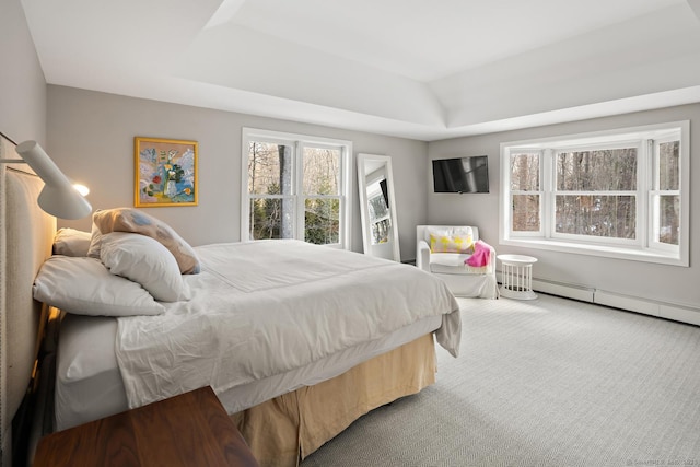 bedroom featuring a tray ceiling, carpet flooring, and baseboard heating