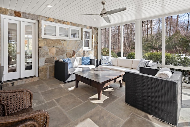 sunroom featuring wooden ceiling and a ceiling fan