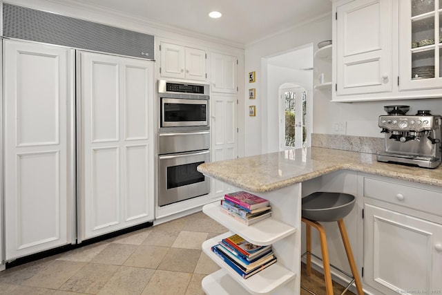 kitchen with white cabinets, arched walkways, open shelves, and built in fridge