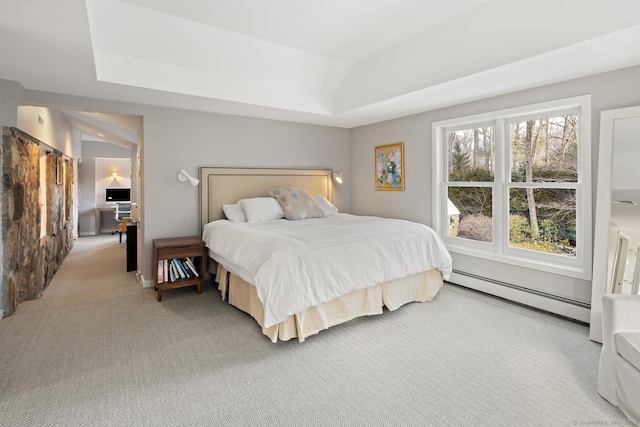 bedroom with a raised ceiling, light carpet, and baseboard heating