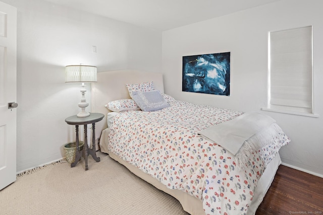 bedroom with wood finished floors and baseboards