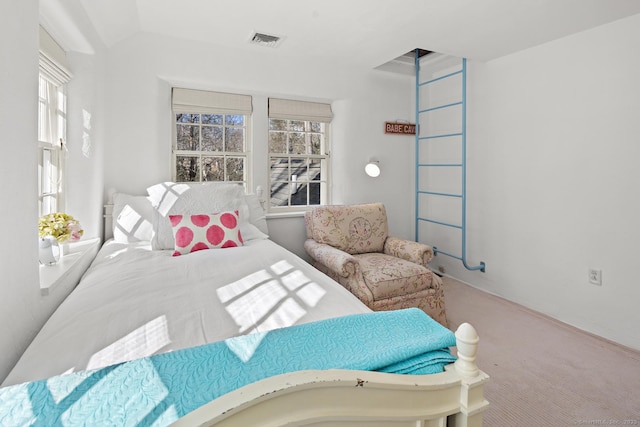 carpeted bedroom featuring visible vents