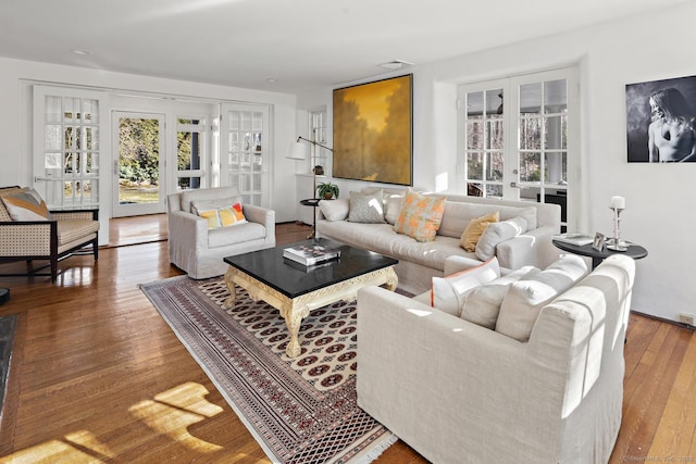 living area featuring visible vents, wood finished floors, and french doors