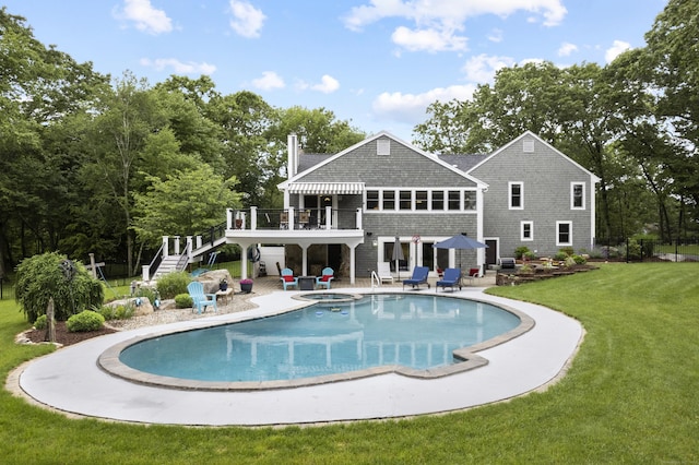 back of house featuring a deck, a patio, stairs, a lawn, and an outdoor pool