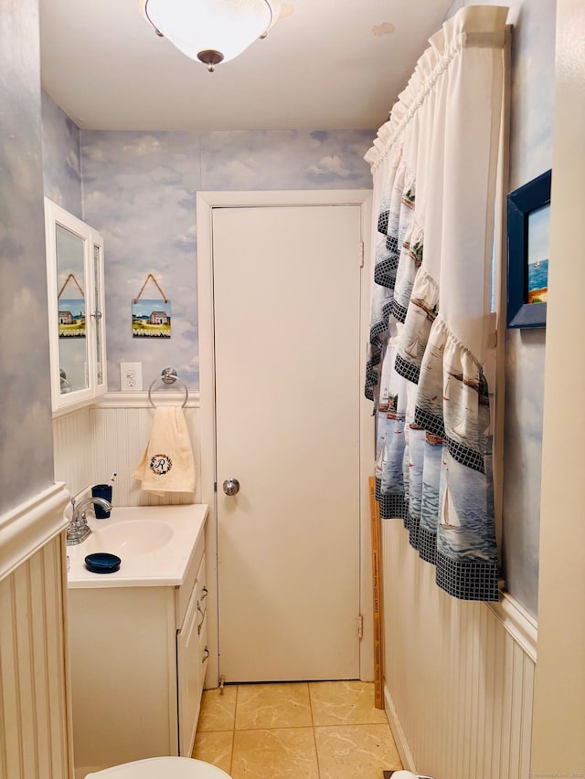 bathroom featuring a wainscoted wall, tile patterned floors, and vanity