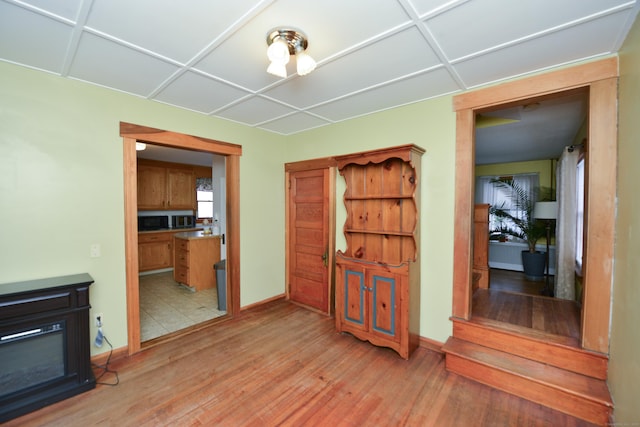 interior space with light wood-style floors and baseboards