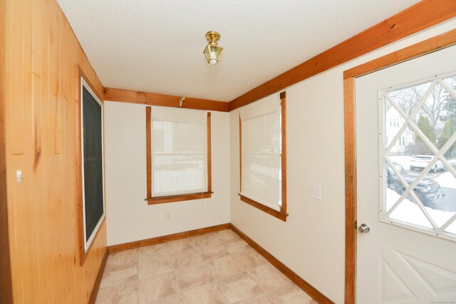 unfurnished bedroom with baseboards and a textured ceiling