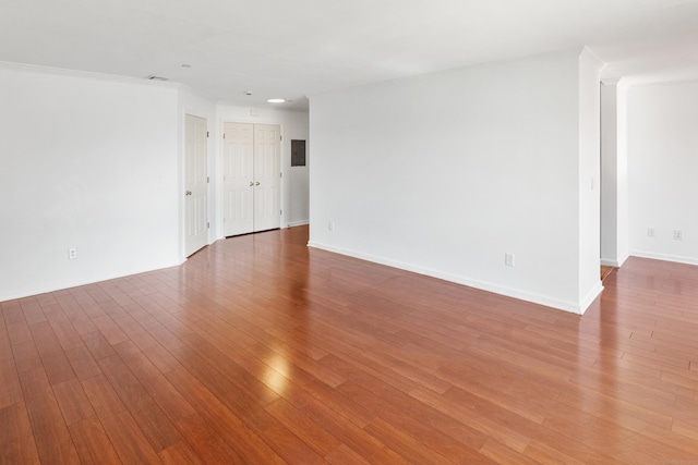 spare room with wood finished floors and baseboards