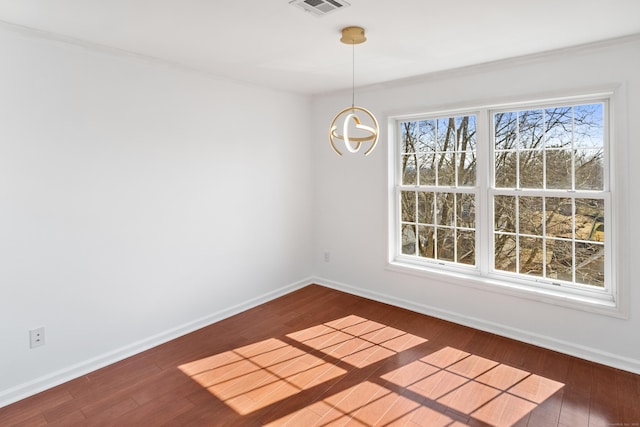 unfurnished dining area with baseboards, visible vents, hardwood / wood-style floors, and an inviting chandelier