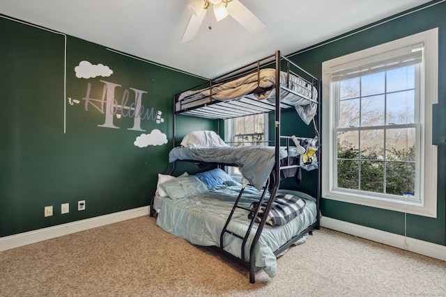 bedroom with carpet floors, baseboards, and a ceiling fan