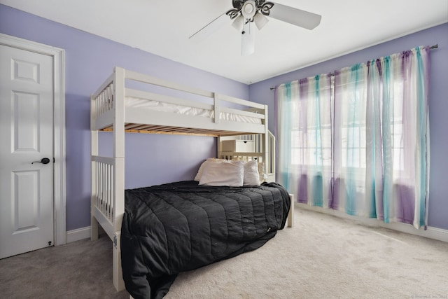 carpeted bedroom with a ceiling fan and baseboards