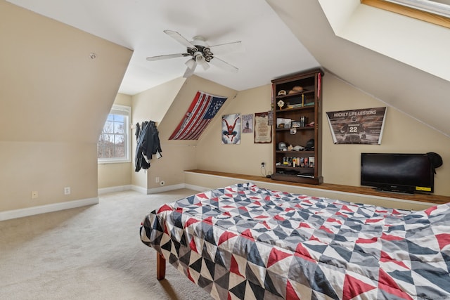 bedroom with carpet, vaulted ceiling, baseboards, and ceiling fan