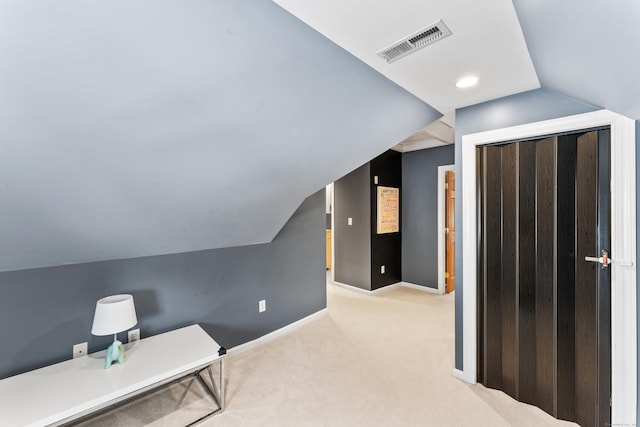 carpeted office with recessed lighting, visible vents, vaulted ceiling, and baseboards