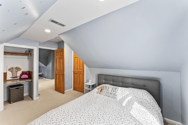 bedroom featuring light carpet, baseboards, visible vents, and vaulted ceiling