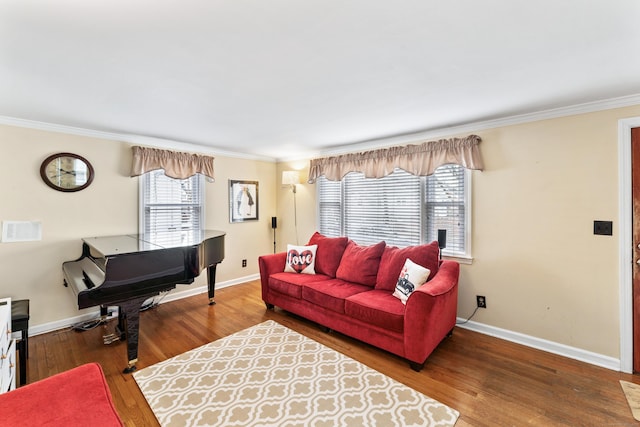 living area with ornamental molding, baseboards, and wood finished floors