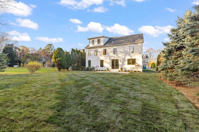 rear view of house featuring a yard