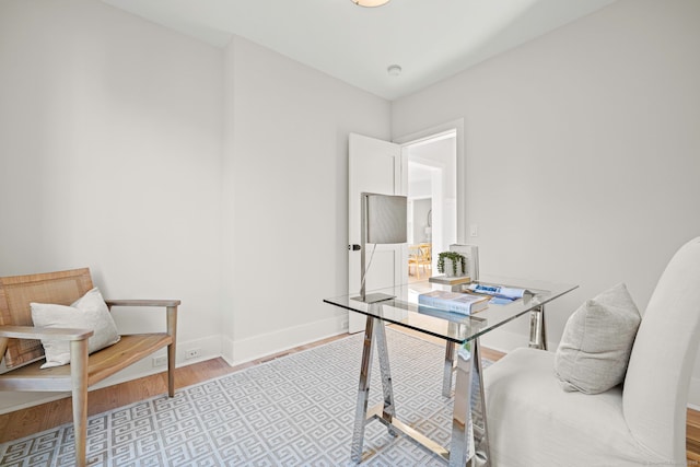 office space featuring baseboards and wood finished floors