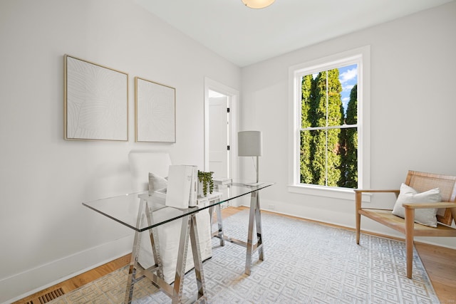 office area with baseboards and wood finished floors