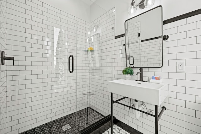 bathroom featuring a stall shower and tile walls