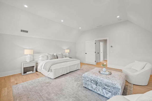 bedroom with baseboards, visible vents, lofted ceiling, light wood-style floors, and recessed lighting