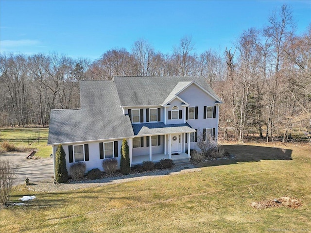 view of front of home with a porch and a front lawn