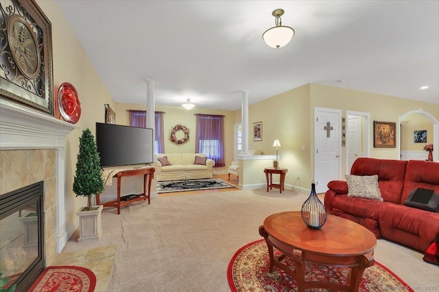 living room with ornate columns, carpet flooring, baseboards, and a tiled fireplace