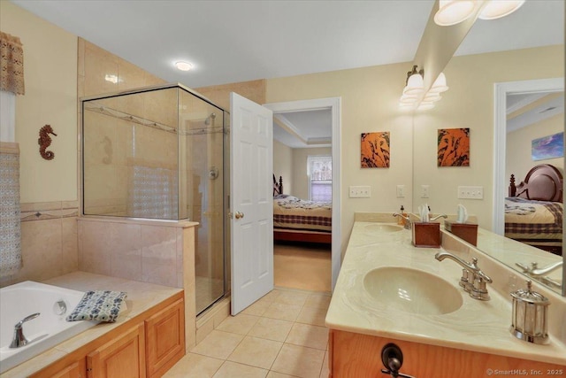 bathroom featuring a sink, tile patterned flooring, and ensuite bath