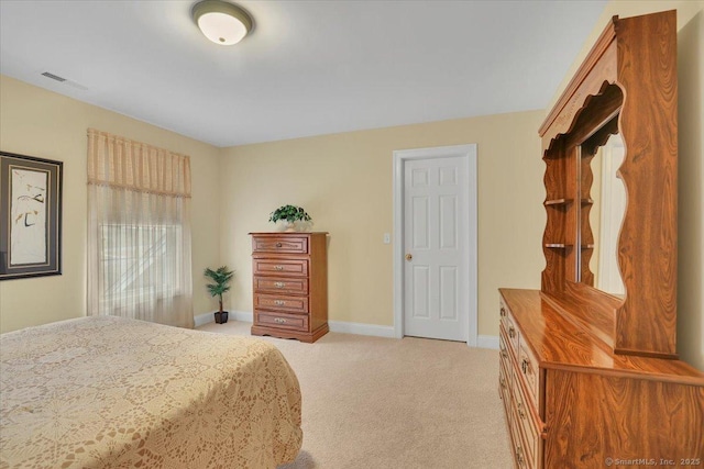 bedroom featuring light colored carpet, visible vents, and baseboards