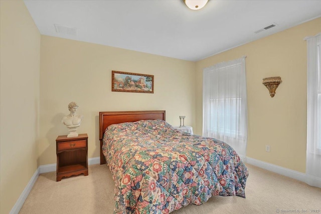 bedroom featuring carpet flooring, visible vents, and baseboards