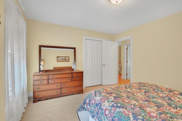 bedroom with a closet and light colored carpet