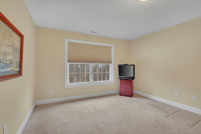 carpeted empty room featuring visible vents and baseboards