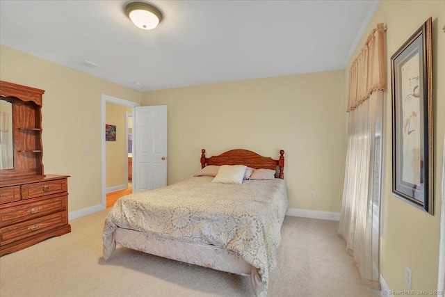 bedroom with light colored carpet, visible vents, and baseboards