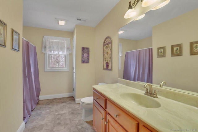 bathroom featuring baseboards, visible vents, a shower with shower curtain, toilet, and vanity