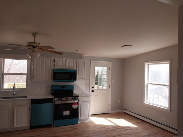 kitchen with black microwave, a sink, baseboard heating, electric range oven, and dishwasher