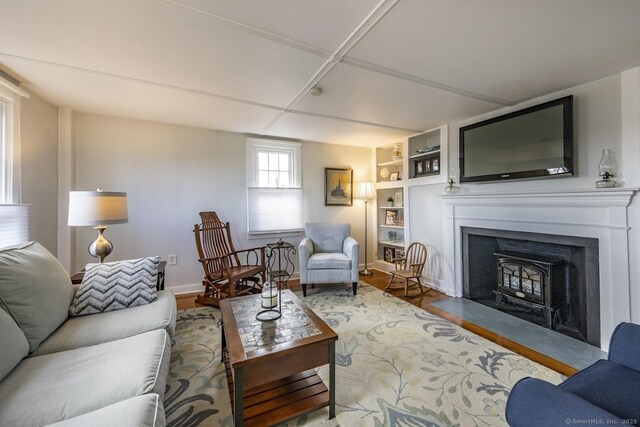 living room featuring built in features and wood finished floors