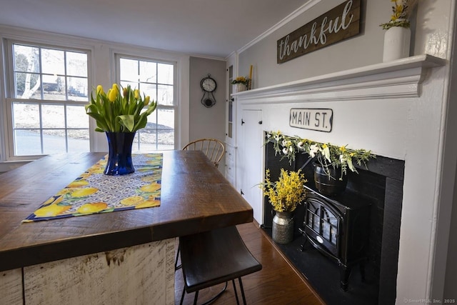 dining area with dark wood finished floors and crown molding