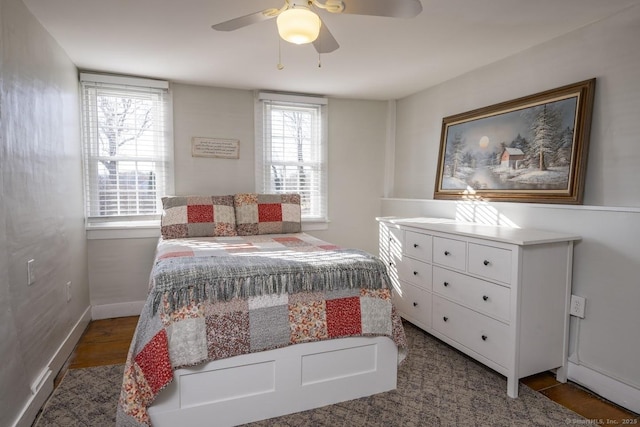 bedroom with a ceiling fan and baseboards