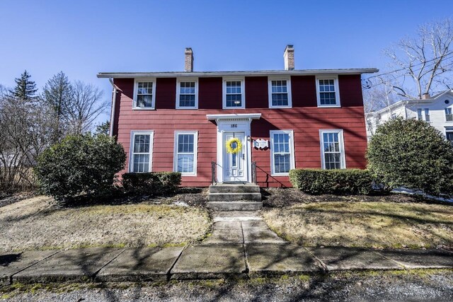 colonial inspired home with a chimney