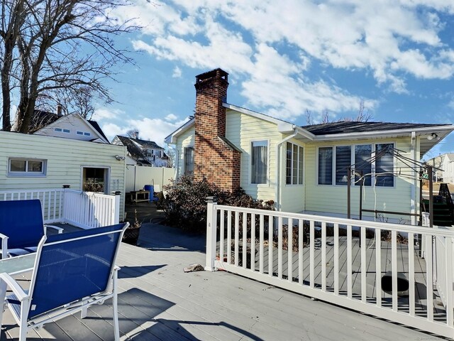 51 Milton Ave, Waterbury, CT 06706 - exterior space with a chimney and a wooden deck