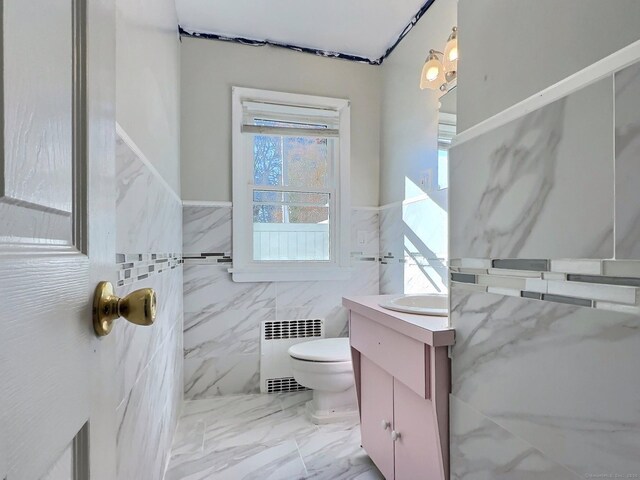 51 Milton Ave, Waterbury, CT 06706 - bathroom featuring toilet, vanity, tile walls, marble finish floor, and radiator heating unit