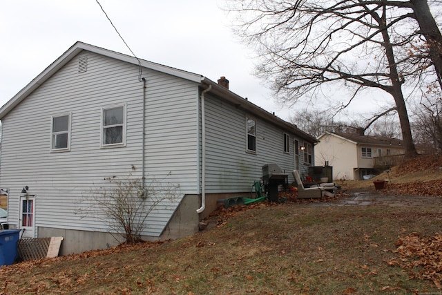 view of side of home with a chimney