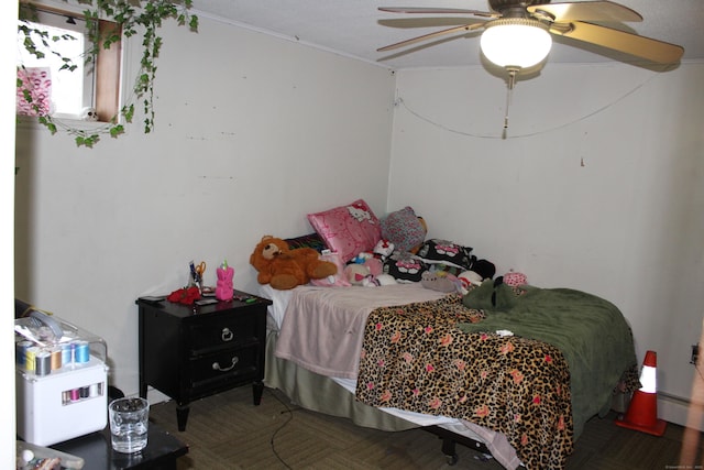 bedroom with ceiling fan and baseboard heating